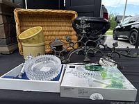 Overview of lot showing wicker basket, planters, cast-iron decor, lantern, concrete planter, Mikasa set and wind chimes