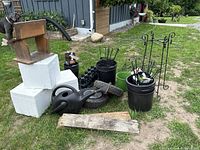 overall view of pots, watering can, tires, Styrofoam blocks, barn board
