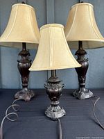 Three matching lamps with shades shown together