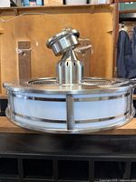 Side view of brushed nickel drum ceiling fan with integrated light