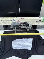 Box showing Napoleon Commercial Quality Rotisserie Kit with contents laid out