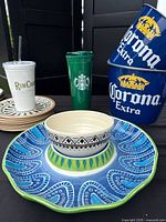 Assorted lot showing chip and dip set, plates, Corona buckets, Starbucks and RumChata tumblers