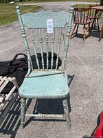 Front view showing the full chair, spindle design on backrest, and broken seat area.