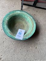 Top-down view showing the full interior of the copper bowl with heavy green patina and weathered surface.