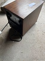 View from the rear showing the power cord and wood-like sides of the heater.