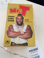 Photo of the original yellow box for the Mr T Giant Card Game featuring a large image of Mr T with crossed arms.