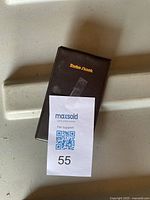 Closed view of the black protective cover with RadioShack printed on it.