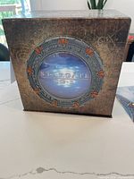 Front of the outer collector's edition box with Stargate SG-1 themed emblem.
