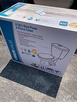 Box of Uberhaus 4.1/6 litre dual flush 2-piece toilet with product details and features on sides of the box.