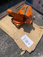 Orange Pony brand cast iron bench vice set on cardboard outdoors showing overall condition and size.