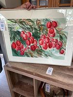 Full view of the watercolour painting showing red berry clusters, green leaves, in a white mat and silver frame with broken glass on the top left corner