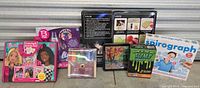 Full view of all 7 kits in the lot including Barbie, Spirograph, BTS Diamond Art, markers, slime lab, and lava lamp kit.