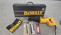 DEWALT reciprocating saw, instruction manual, and multiple saw blades displayed on flat surface.
