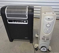 Side view of two space heaters placed on the floor, showing size and features
