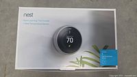 Closed retail box packaging showing Nest Learning Thermostat and Nest Temperature Sensor graphics.