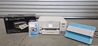 Overview: Epson printer center, HP OfficeJet 100 box left, Plustek scanner right, photo paper front left