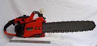 Left side view Echo 550 VL chainsaw with 16-inch bar, ruler for scale