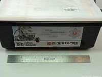 Front of storage bin showing set label and ruler for scale