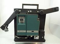 Front view showing full projector body with autoload arm extended