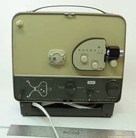 Front view of Kodak Brownie 500 projector showing lens assembly, controls and attached power cord