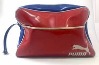 Front view of red and blue Puma sports bag