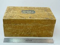 Closed wooden storage box with Stanley Tools decal and ruler for scale