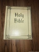 Photo of the white hardcover Bible front cover with 'Holy Bible' embossed text.
