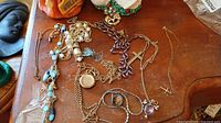 Cluster of all necklaces on wood table