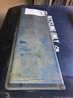 Closed blue plastic case for socket set with visible dirt and wear.