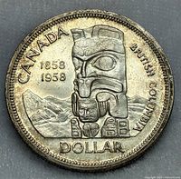 Close-up photo of the coin front showing the totem pole design and inscriptions.