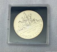 Front view of the 1987 Canadian Davis Strait silver dollar coin showing detailed ship design and text, in clear protective plastic casing.