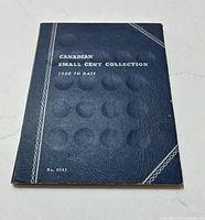 Blue hardcover coin collection book titled 'Canadian Small Cent Collection 1920 to Date No. 9062'.