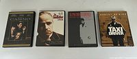 Four DVD cases lined up: Casino, The Godfather, Scarface, and Taxi Driver.