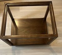 View showing empty walnut wooden frame without glass, emphasizing construction and wood grain