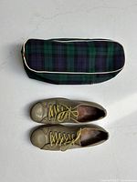 Top view showing pair of light olive green leather bowling shoes with yellow laces and matching zipped tartan carrying case