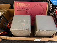 Front view two Realistic Minimus 7 speakers, Topping amp box, walkie-talkie visible