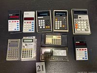 Group shot of all ten calculators laid out on table