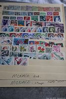 Photo of first stock sheet showing multiple rows of mint hinged and used Monaco stamps with varied themes and colors