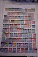 Front side of one sheet showing multiple rows of French postage stamps in various colors and designs, mostly rectangular and square, with many cancellation marks.