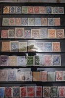 First stock page showing multiple rows of early Russian Empire postage stamps including various values and colors with imperial eagle designs and some postal cancellation marks.