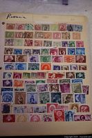 Full view of one stock sheet with approximately 60 Romania stamps arranged in rows, various colors and designs, some postmarked.