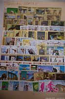 Photo showing a stock sheet densely covered with various Trucial States stamps depicting wildlife and Olympic sports figures.