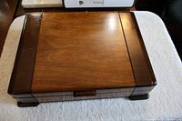 Closed polished wooden box housing the Rogers Bros. cutlery set from top view