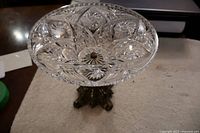 Top view showing detailed cut crystal bowl with starburst design and scalloped edge.