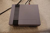 Top view of the compact gray Nintendo NES Mini console showing vent design and general condition.