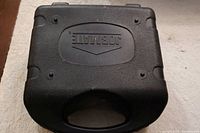 Closed black plastic Jobmate tool box case with molded handle and logo on top