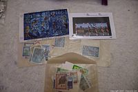 Small collection of assorted United Nations stamps displayed on a flat surface with two envelopes and loose stamps.