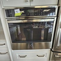 Installed GE Profile built-in convection wall oven in cabinetry showing front view and stainless steel finish