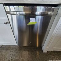 Front closed view of stainless steel door with rounded handle and lot sticker