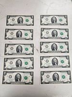 Fronts of ten sequential $2 bills showing serial numbers and condition